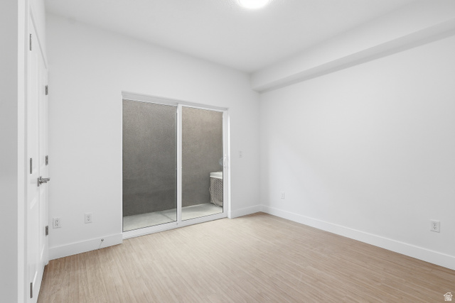2085 North Main Street, Unit 409 Sunset, UT 84015 - Photo 5 of 17 Bedroom opens to deck featuring light wood-type flooring and access to outside