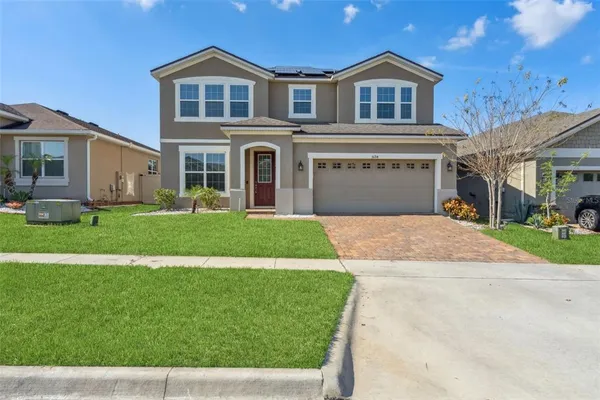 a front view of a house with a yard and garage