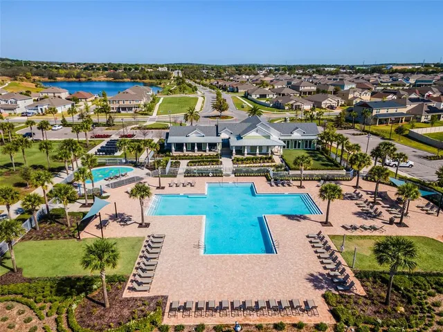 an aerial view of residential building with outdoor space and ocean view