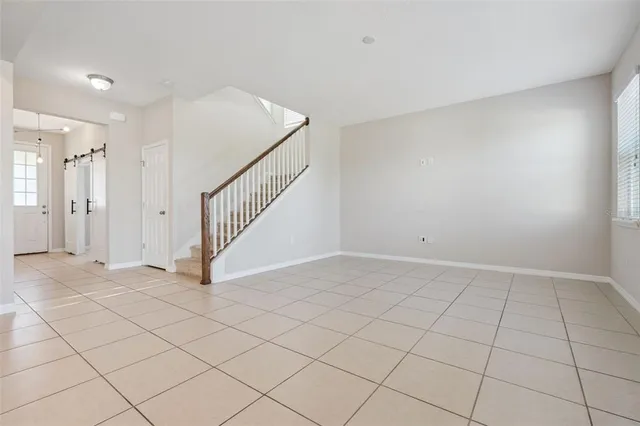 a view of an empty room and staircase