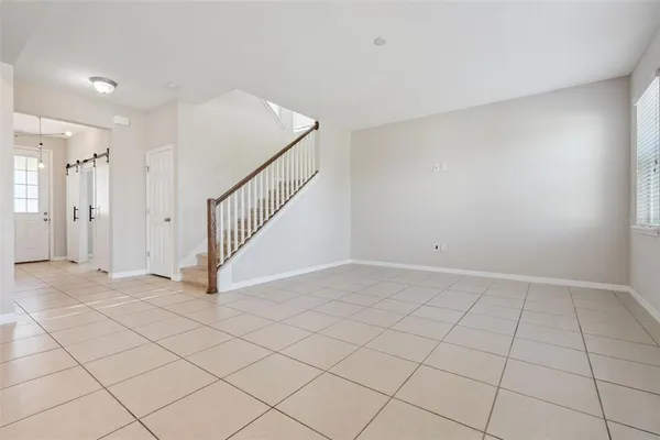 a view of an empty room and staircase