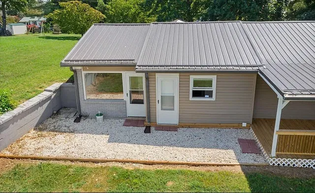 an aerial view of a house with a garden and deck