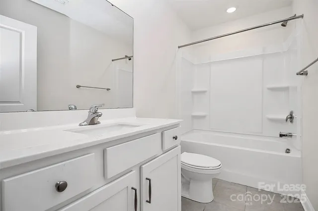 a bathroom with a sink toilet vanity and shower