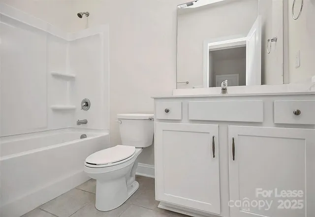 a bathroom with a sink toilet vanity and tub