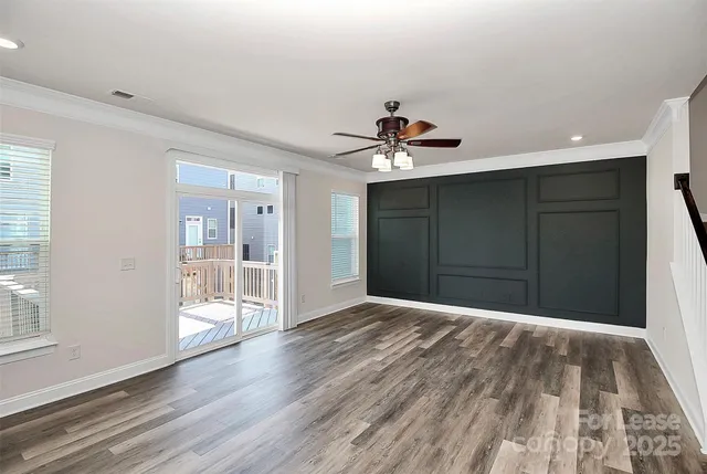 a view of a hallway with wooden floor and chandelier