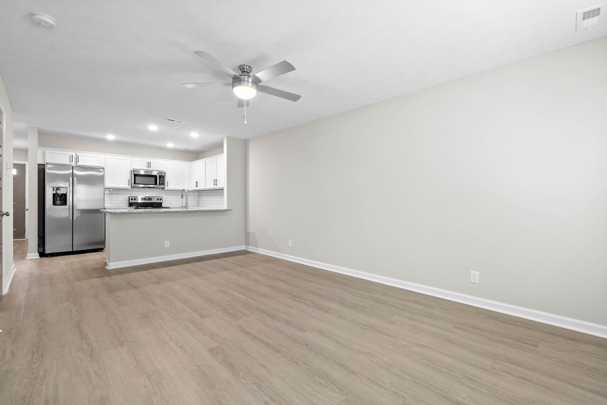319 Longshadow Trail, Unit A Clarksville, TN 37043 - Photo 14 of 29 a view of a kitchen with a dishwasher cabinets and a wooden floor