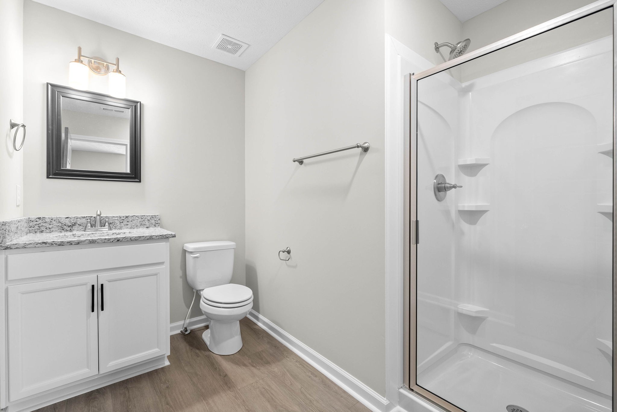 319 Longshadow Trail, Unit A Clarksville, TN 37043 - Photo 18 of 29 a bathroom with a granite countertop toilet a sink and a mirror