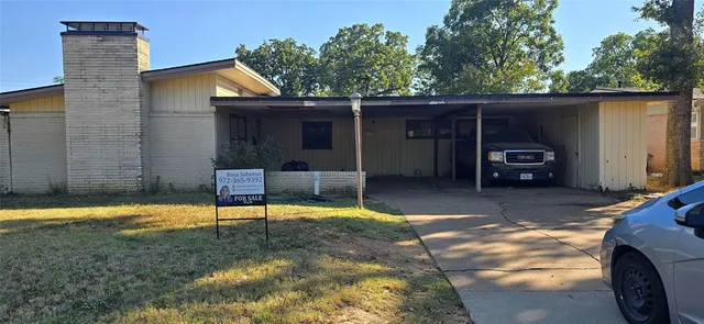 a view of a chair and table in backyard of the house
