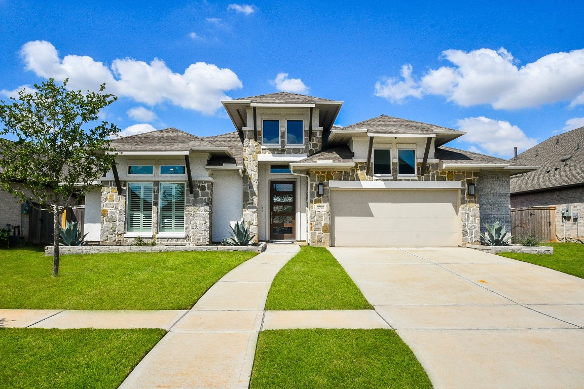 a front view of house with yard and green space