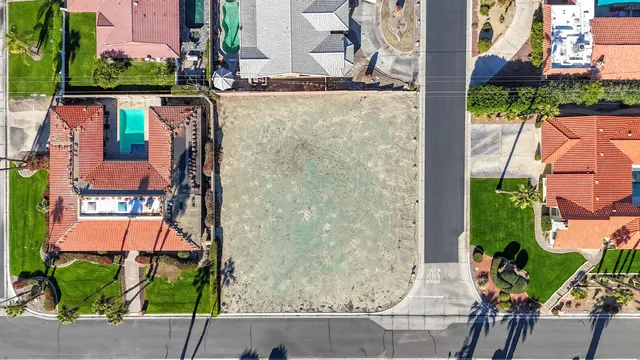 an aerial view of a house with a yard and large trees