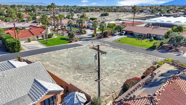 an aerial view of a house with a yard and lake view