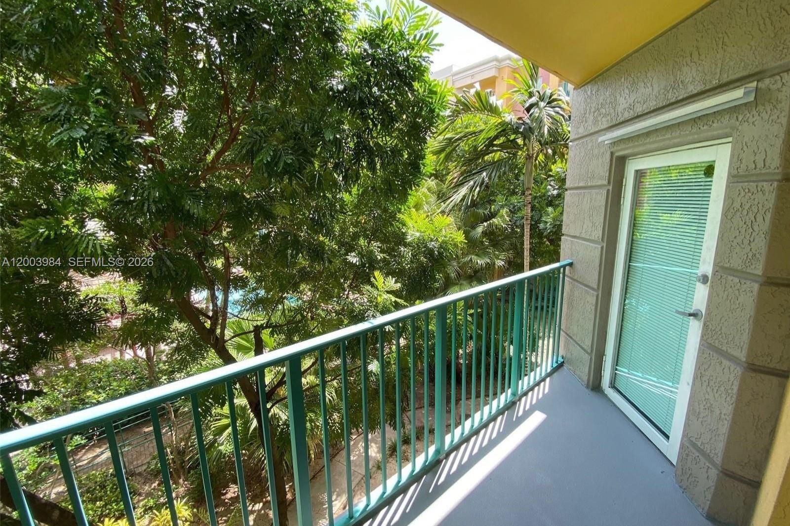 6001 Southwest 70th Street, Unit 342 South Miami, FL 33143 - Photo 12 of 19 a view of balcony with wooden floor and fence