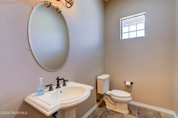 a white toilet sitting next to a bathroom sink