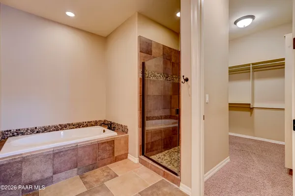 a bathroom with a tub and shower