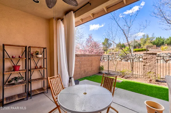a view of a porch with furniture and a backyard