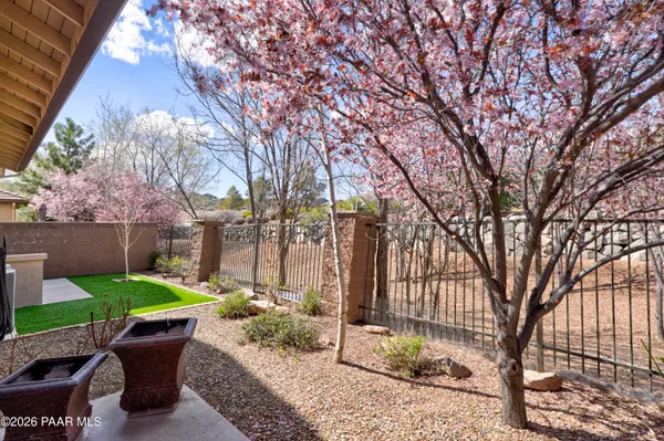 a view of a backyard with table and chairs and a fire pit