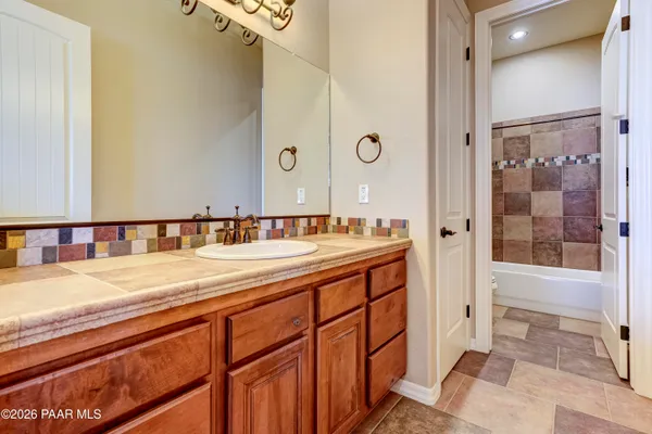 a spacious bathroom with a shower sink and mirror