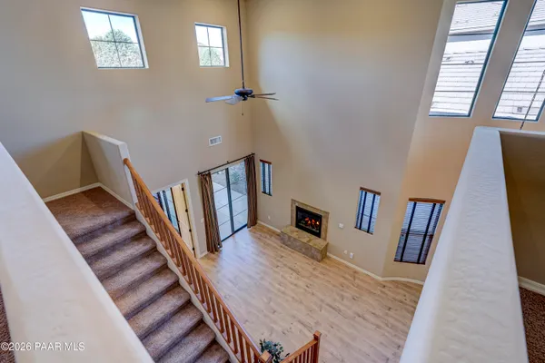 a view of a livingroom with wooden floor and stairs