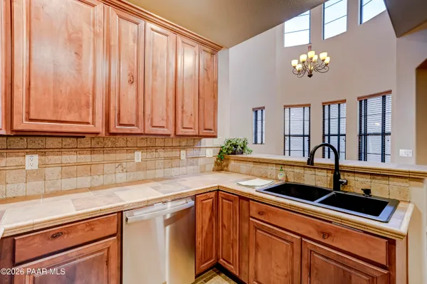 a kitchen with stainless steel appliances granite countertop a sink dishwasher and cabinets with wooden floor
