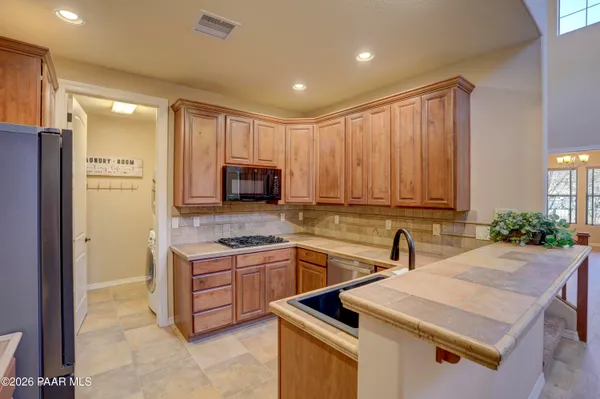 a kitchen with a sink refrigerator and cabinets