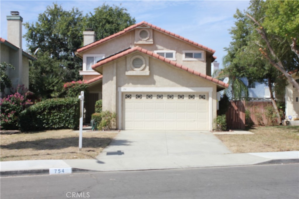 754 De La Luz Circle Perris, CA 92571 - Photo 1 of 1 a front view of a house with garden