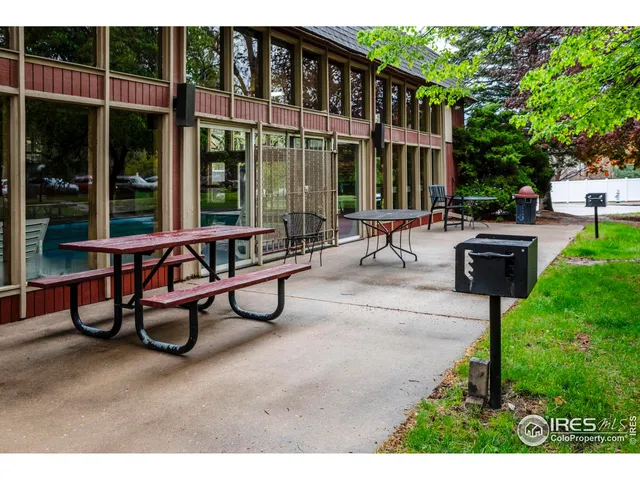 a view of a building with sitting area and garden