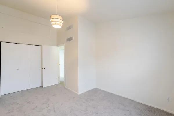 a view of a room with windows and ceiling fan