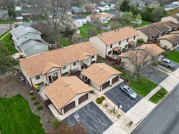 an aerial view of a house with garden space and street view