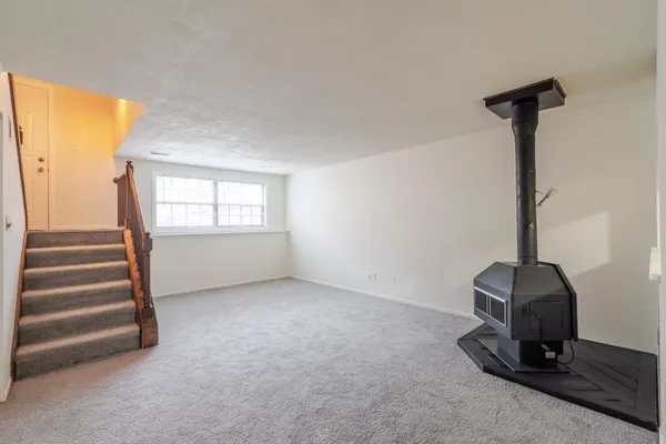 a kitchen with granite countertop a stove a sink and a refrigerator