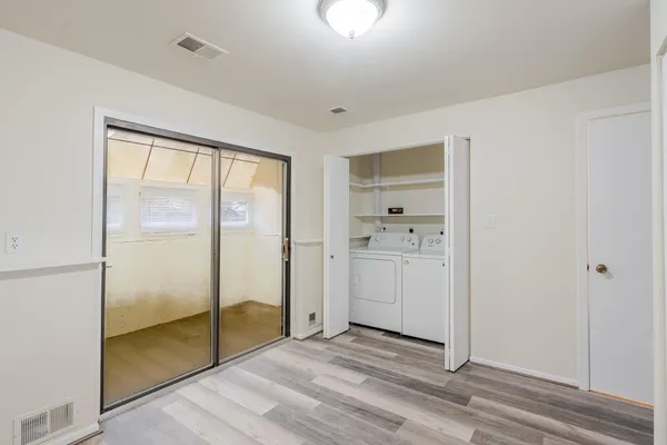 a kitchen with a sink cabinets and wooden floor