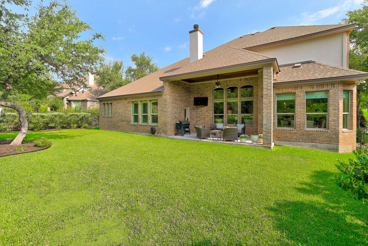 809 Prairie Dunes Drive Georgetown, TX 78628 - Photo 40 of 40 A spacious backyard with a manicured lawn and a covered patio, perfect for outdoor enjoyment.