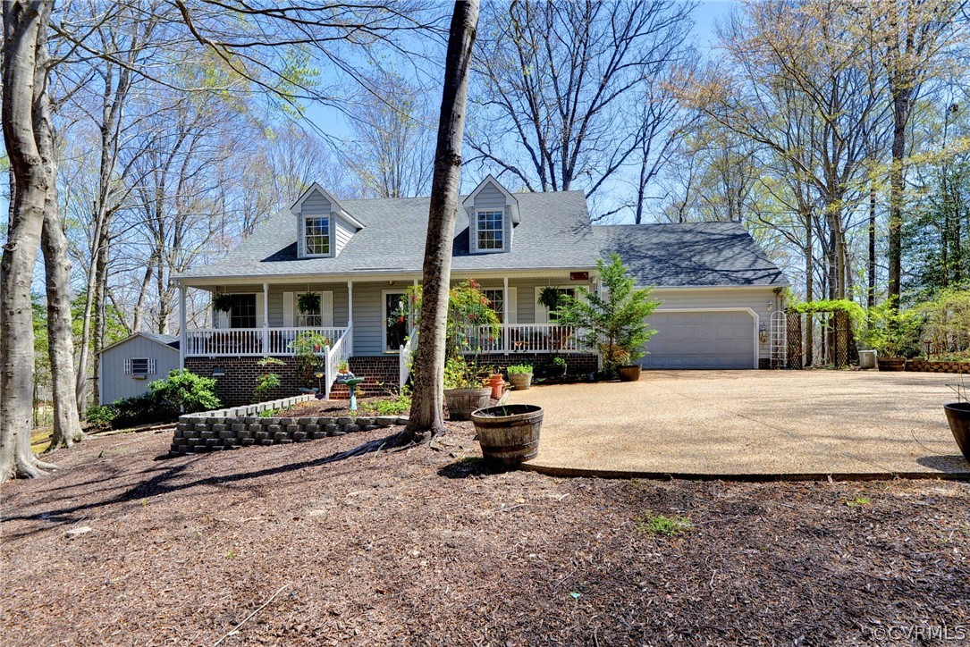 a view of a house with a patio and a yard