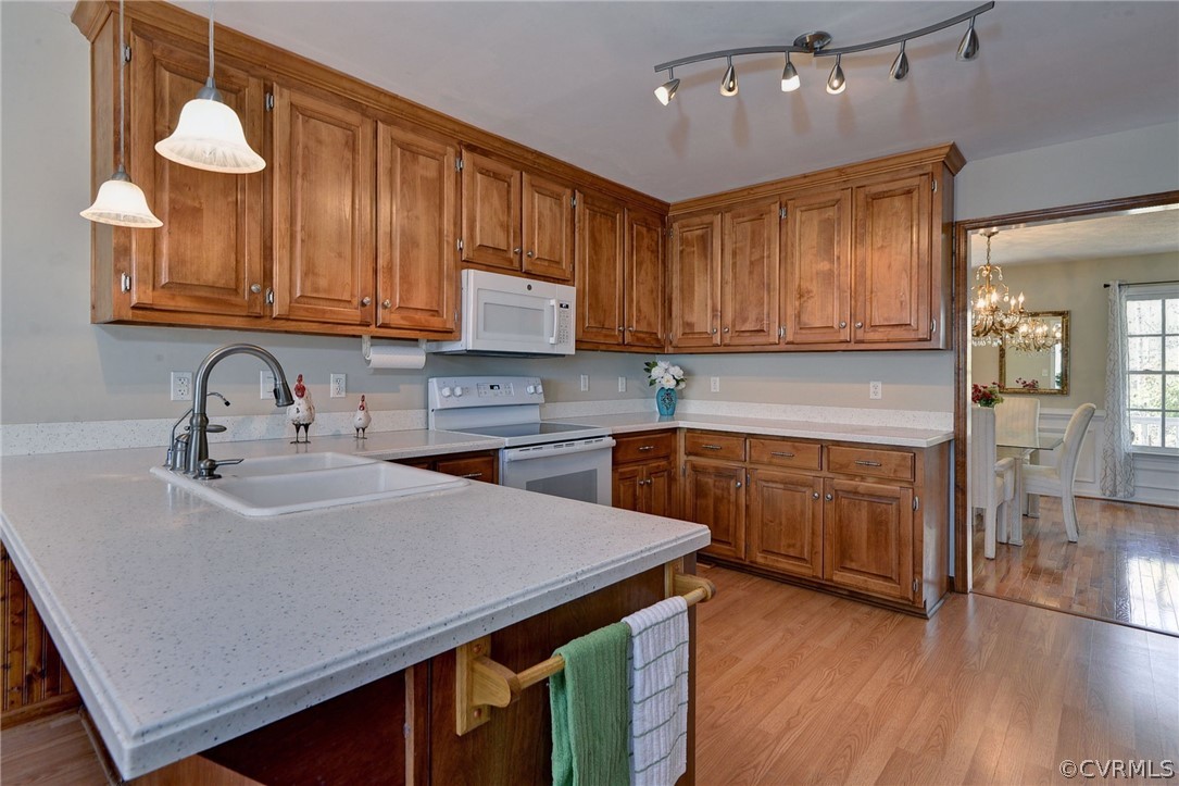 110 Westminster Place Williamsburg, VA 23188 - Photo 30 of 50 a kitchen with granite countertop a sink cabinets and wooden floor