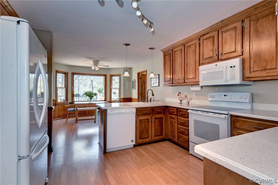 110 Westminster Place Williamsburg, VA 23188 - Photo 32 of 50 a kitchen with stainless steel appliances granite countertop a refrigerator a sink dishwasher a stove and white countertops with wooden floor