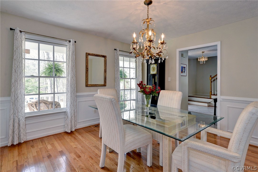 110 Westminster Place Williamsburg, VA 23188 - Photo 34 of 50 a dining room with furniture a chandelier and wooden floor