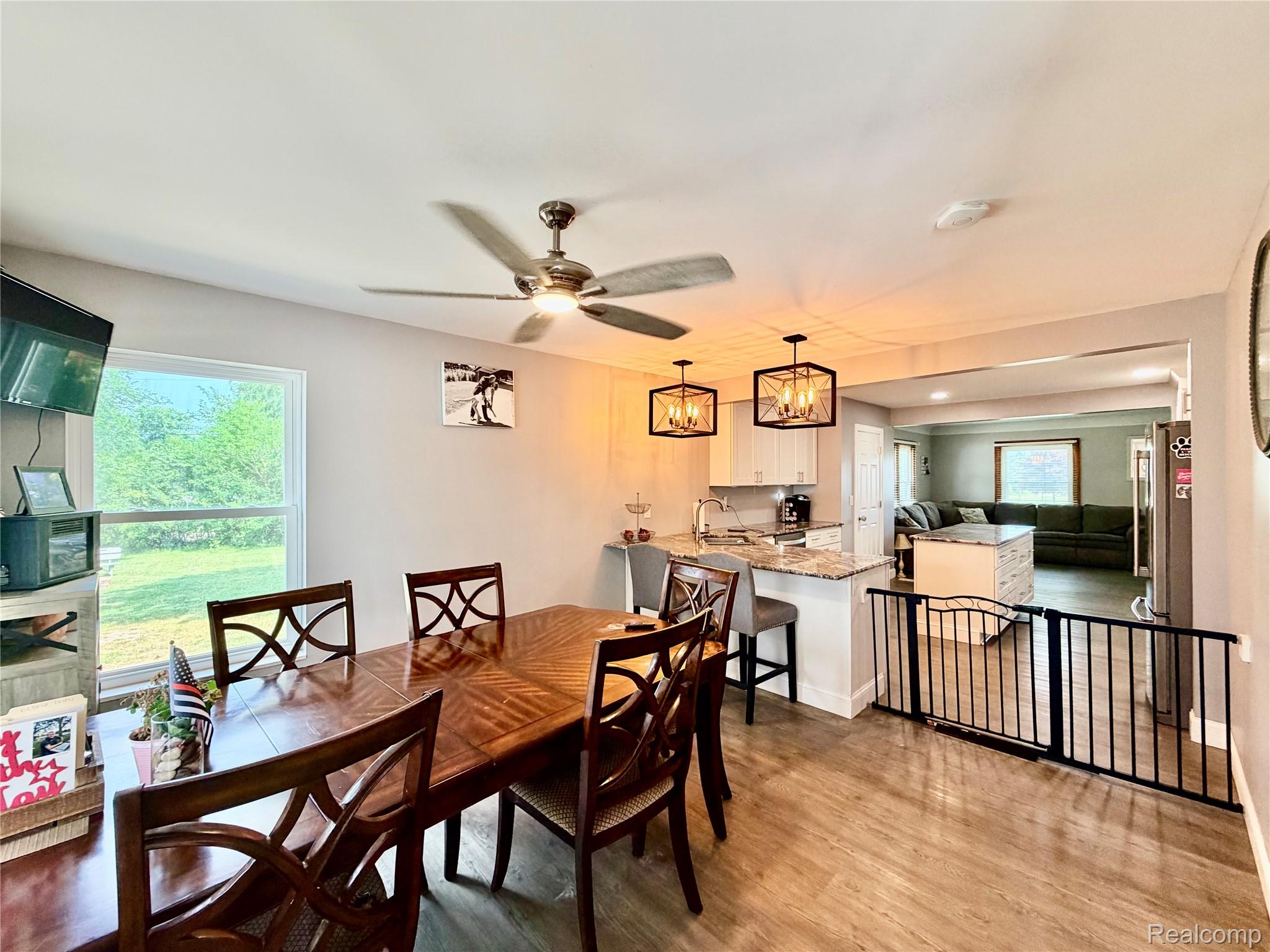3840 East Dunbar Road Monroe, MI 48161 - Photo 22 of 38 Open-concept dining area featuring wood-finish flooring and a ceiling fan