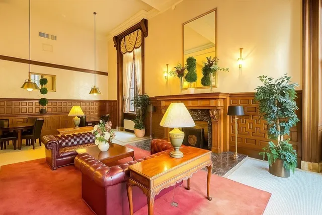 a lobby with furniture and floor to ceiling windows