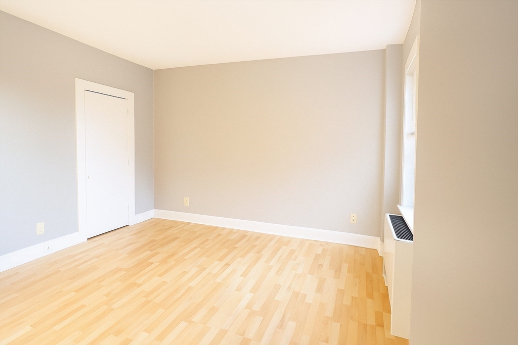 140 Chestnut Street, Unit 709 Springfield, MA 01103 - Photo 7 of 18 a view of an empty room with wooden floor
