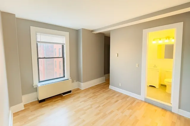 a living room with furniture a fireplace and large windows