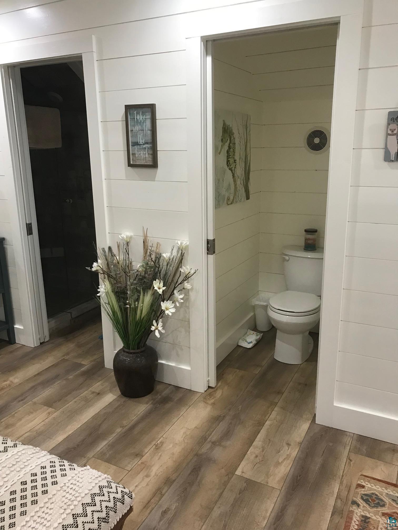 70745 Range Line Road Iron River, WI 54847 - Photo 32 of 40 White shiplap walls complement the wood-finish flooring