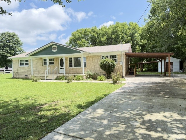 1300 Pleasant Ridge Road Huntland, TN 37345 - Photo 16 of 22 a front view of a house with garden