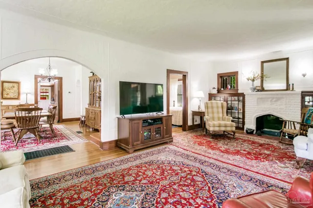a view of a dining room with furniture a chandelier and wooden floor