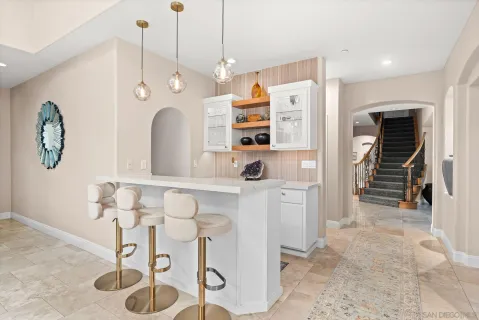 a kitchen with stainless steel appliances kitchen island granite countertop a refrigerator and a sink