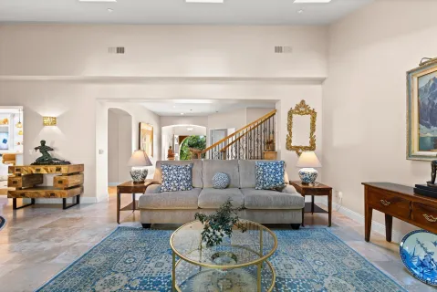 a living room with furniture and a dining table