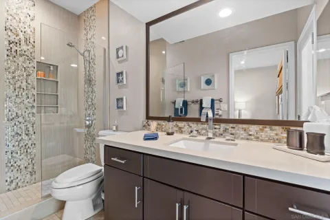 a bathroom with a sink toilet and shower