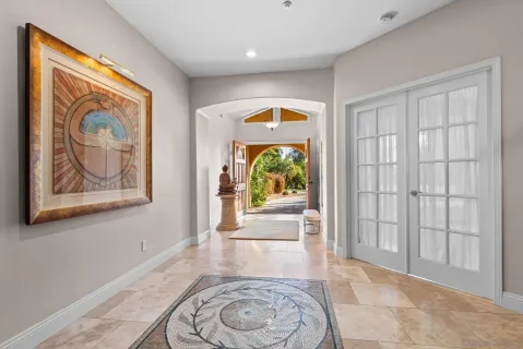 an entryway with wooden floor and front door