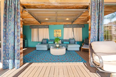 a room with wooden floor and a potted plant