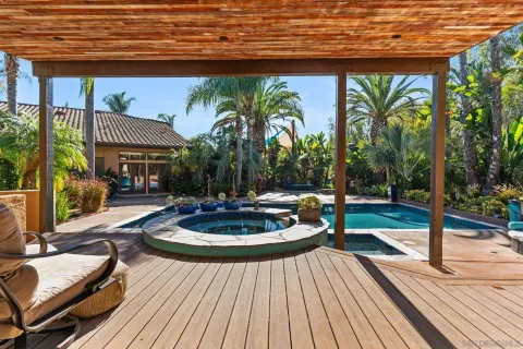 a outdoor view with a sitting space and large trees
