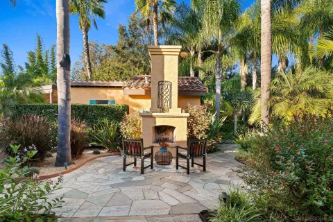 a view of house with yard and furniture