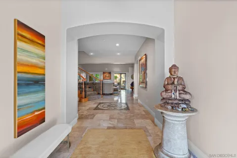 a hallway with a large mirror and dining table